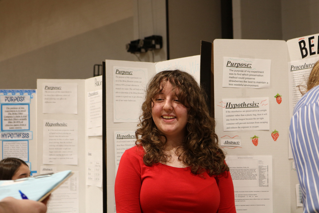 student smiling at science fair