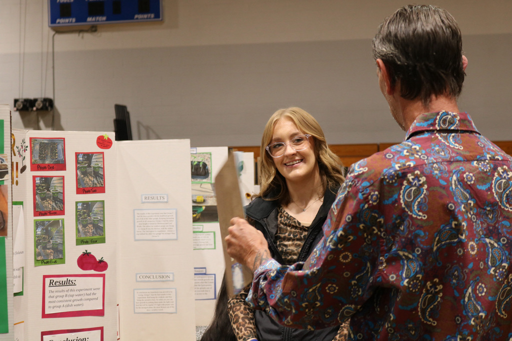 student smiling at science fair