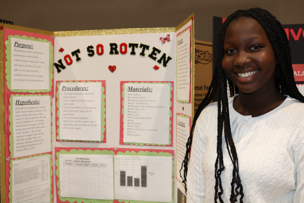 student smiling at science fair