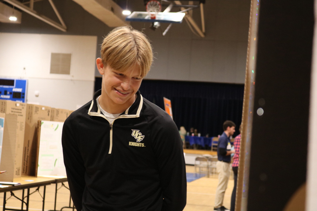 student smiling at science fair