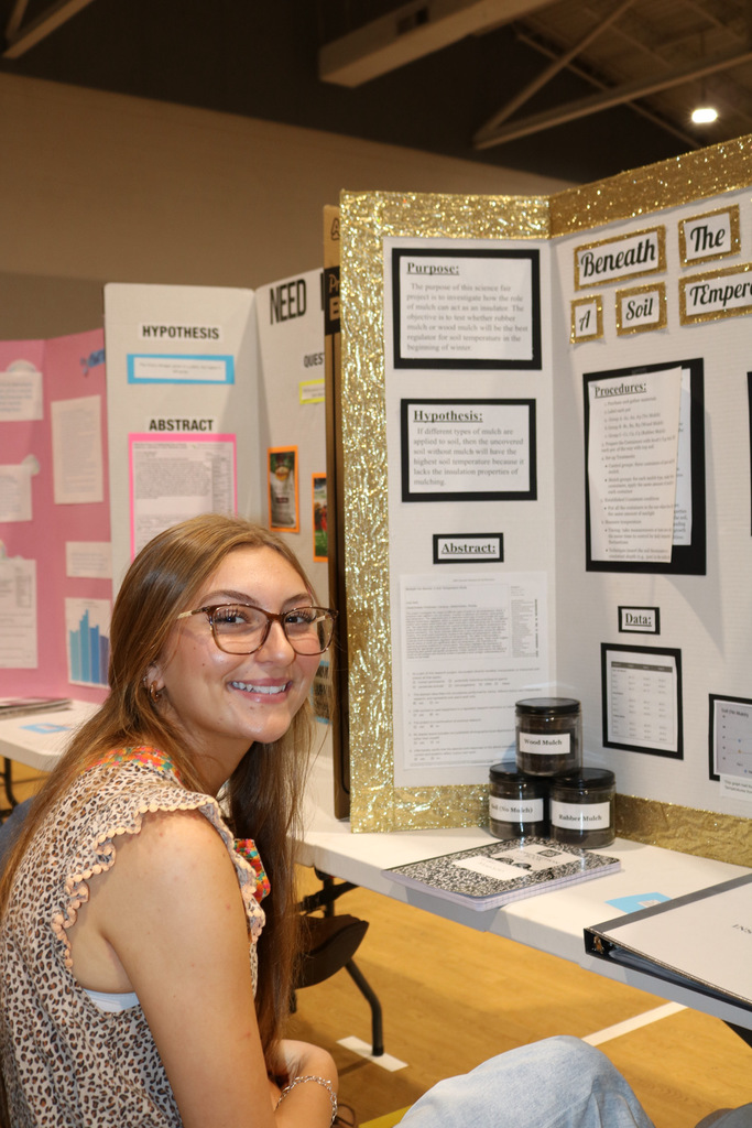 student smiling at science fair