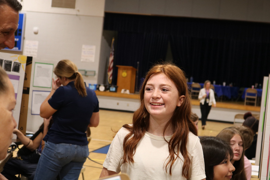 student smiling at science fair