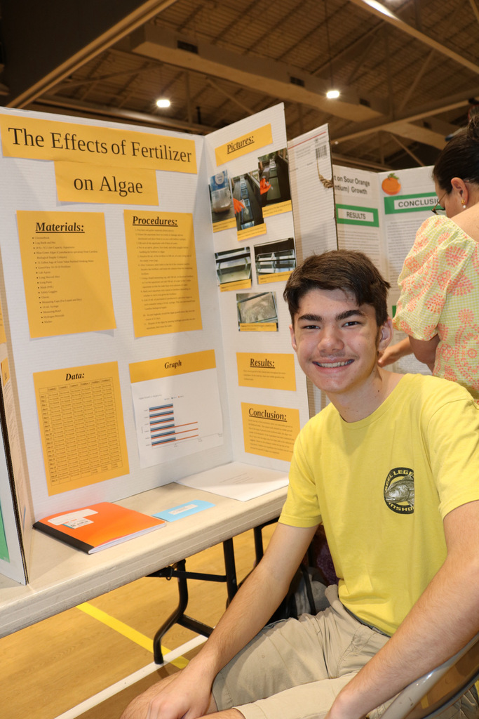 student smiling at science fair