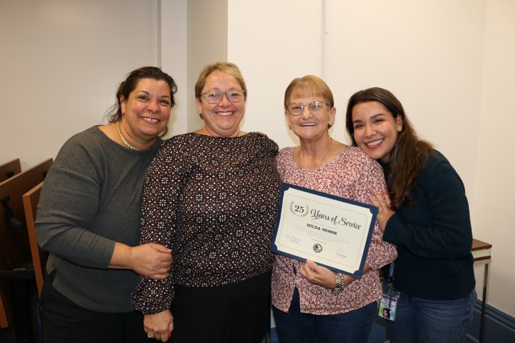 four educators at school board meeting