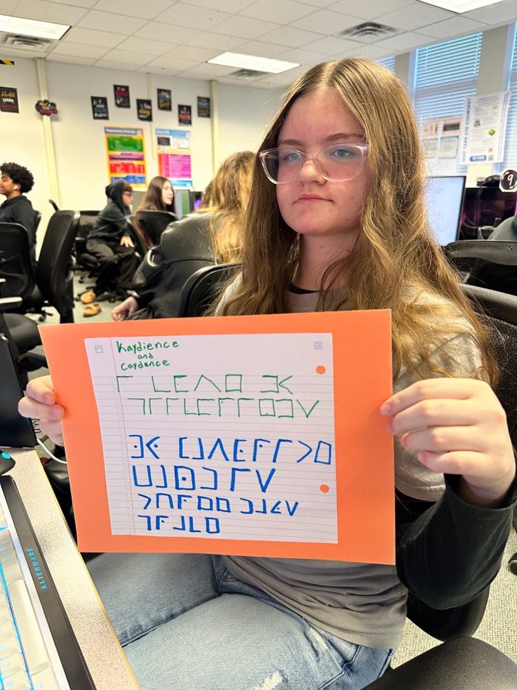 student showing off cipher in technology class