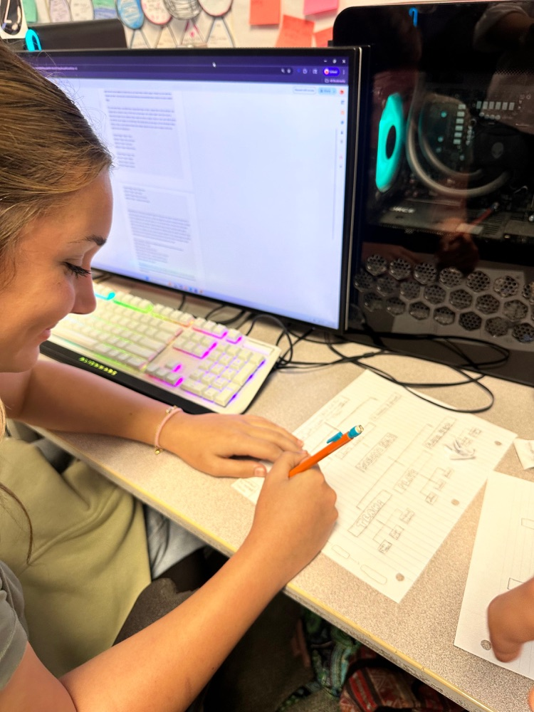 student smiling writing on paper 