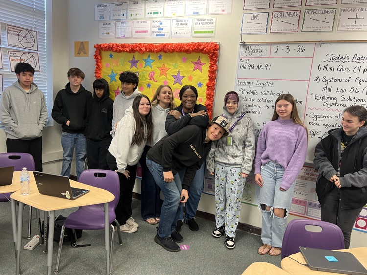 students standing with guidance in class