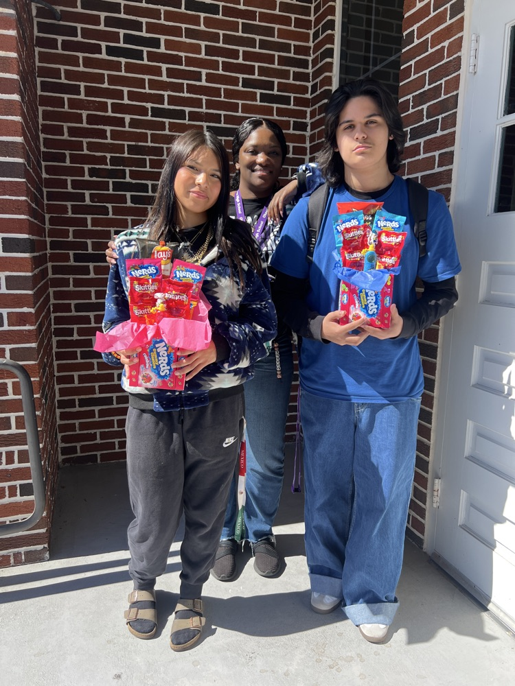 two students with prizes from guidance counselor 