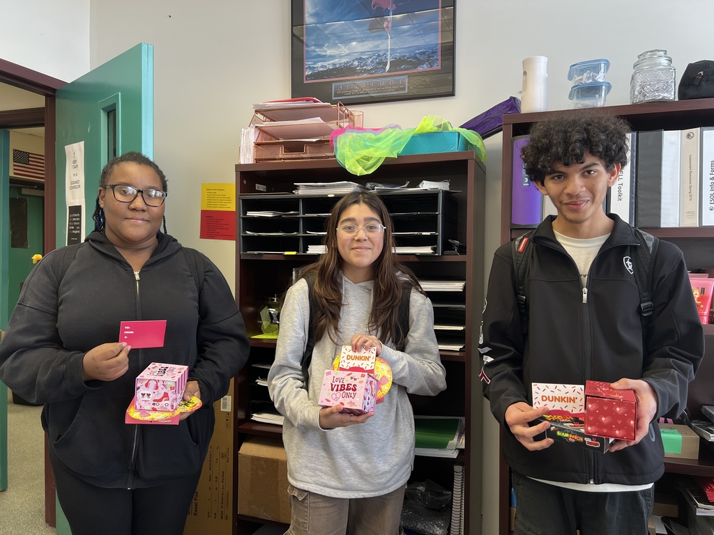 three students with raffle prizes