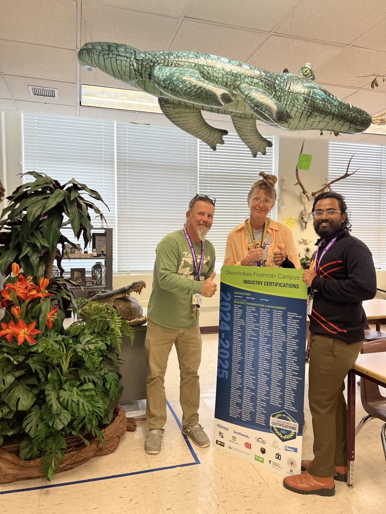 three science teachers holding a big certification list 