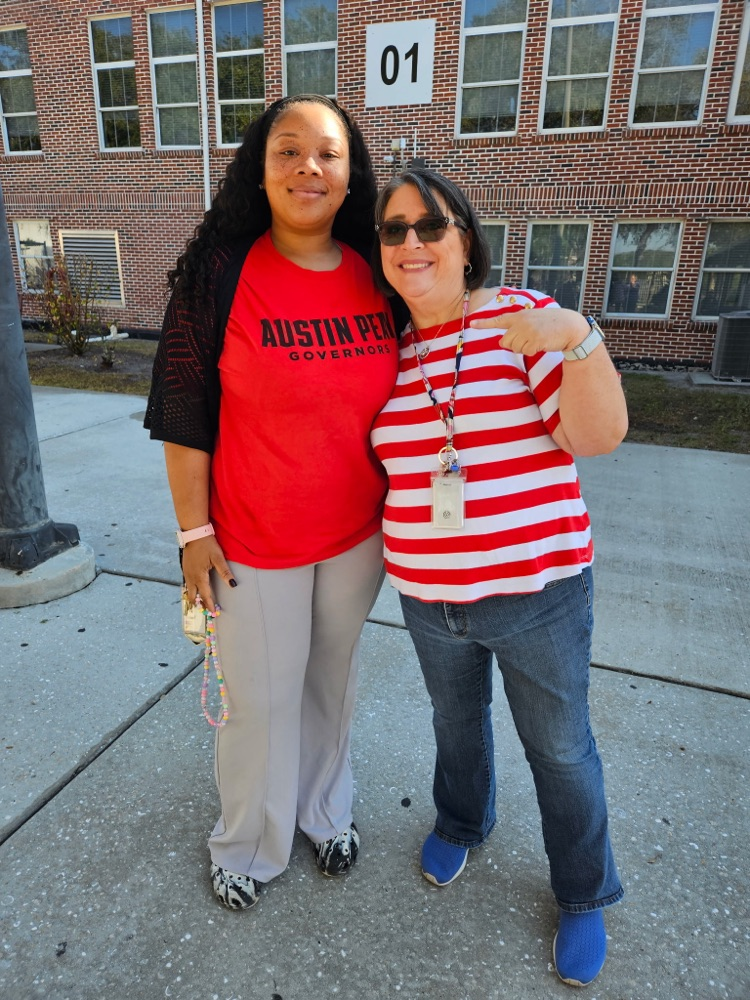 inclusion teacher and English teacher smiling in school courtyard
