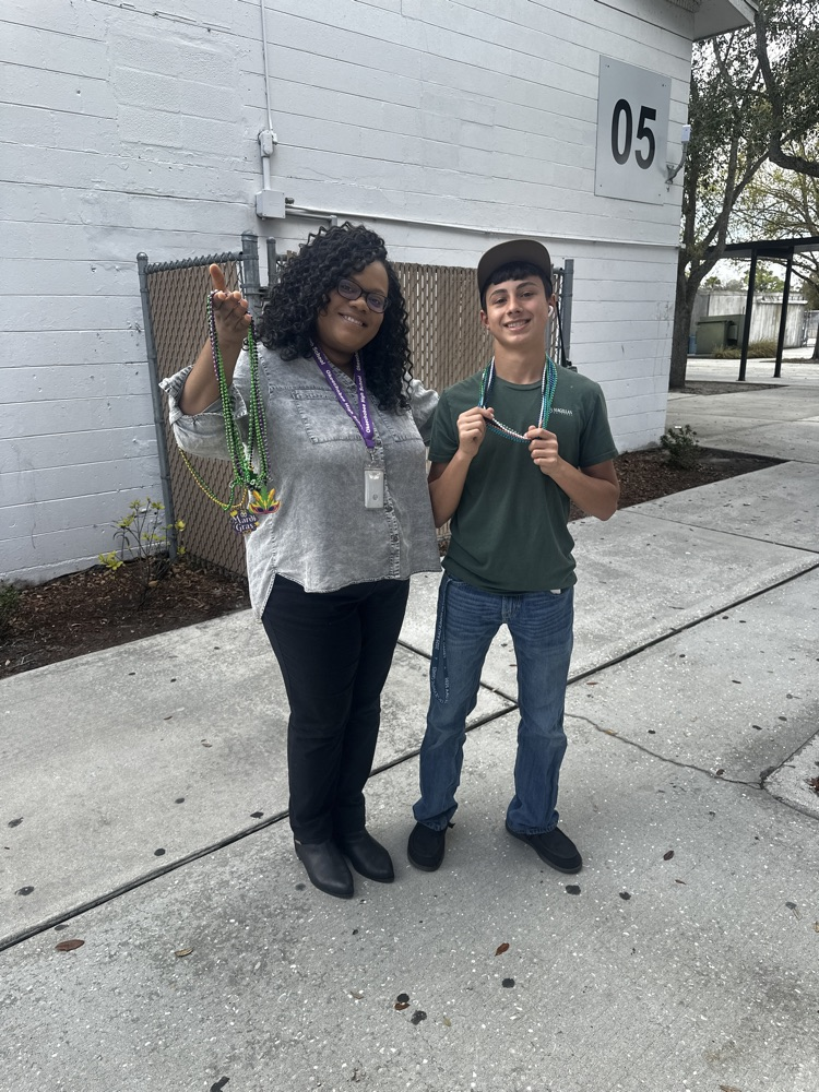 assistant principal with student celebrating Mardi Gras 