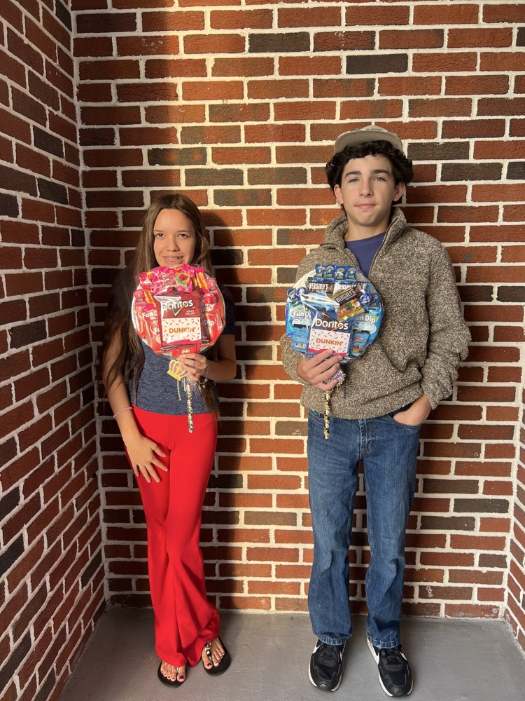 two students with attendance raffle prizes 