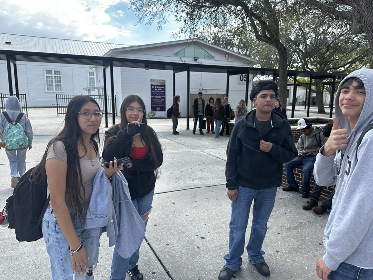 four students in school courtyard