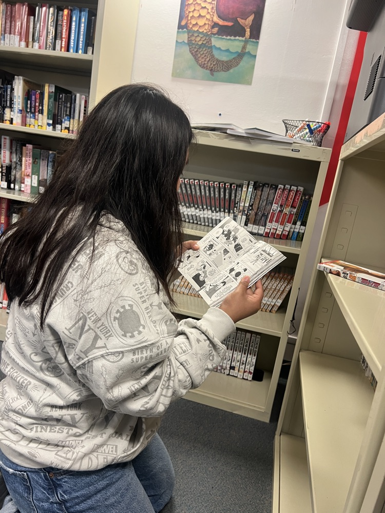 student reading book in library