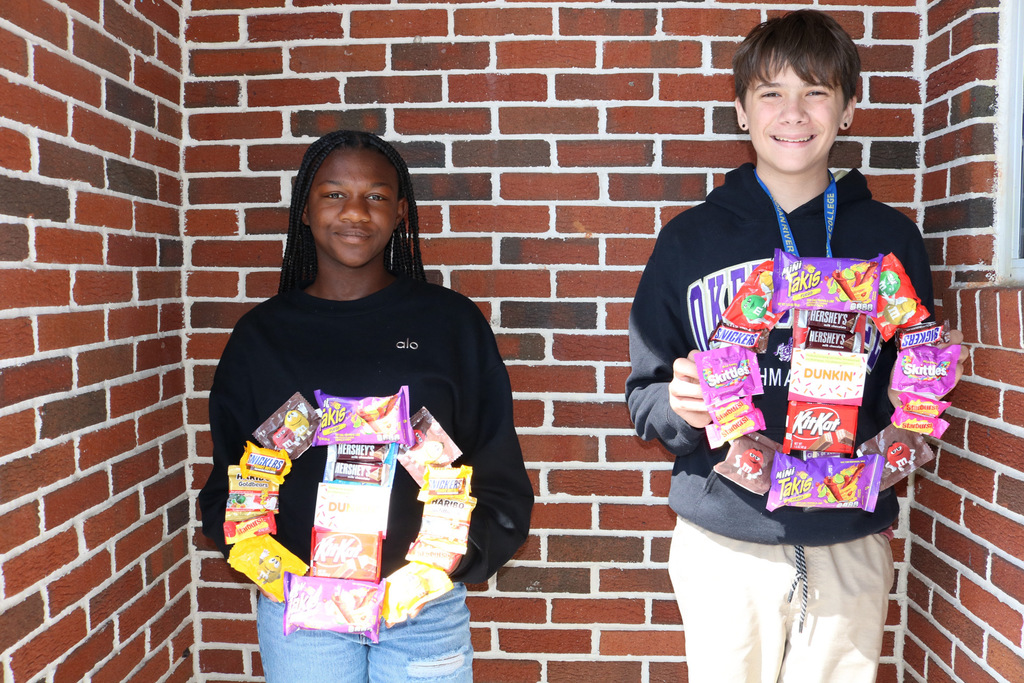 two students holding raffle prizes