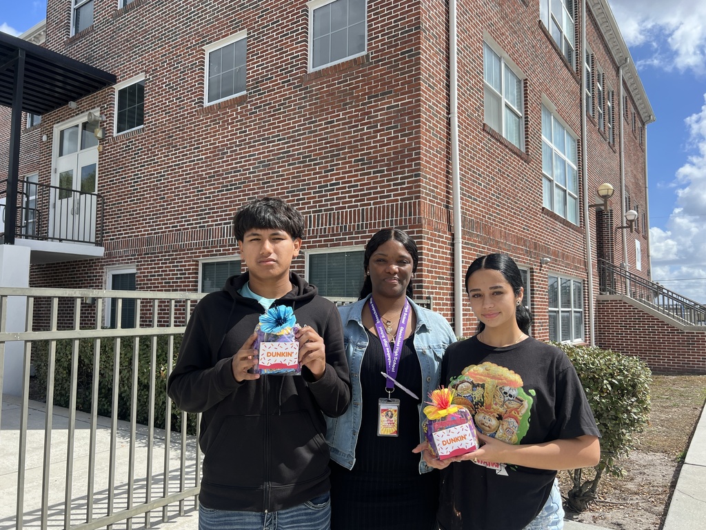 two students and guidance counselor with raffle prizes