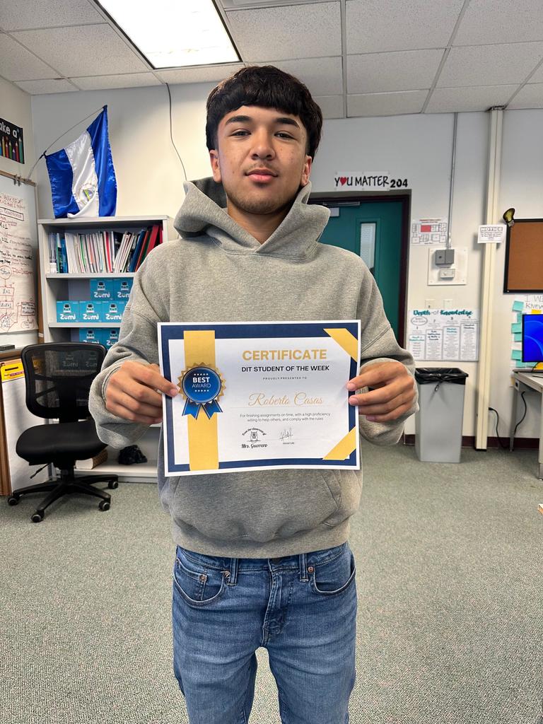 student holding DIT certificate