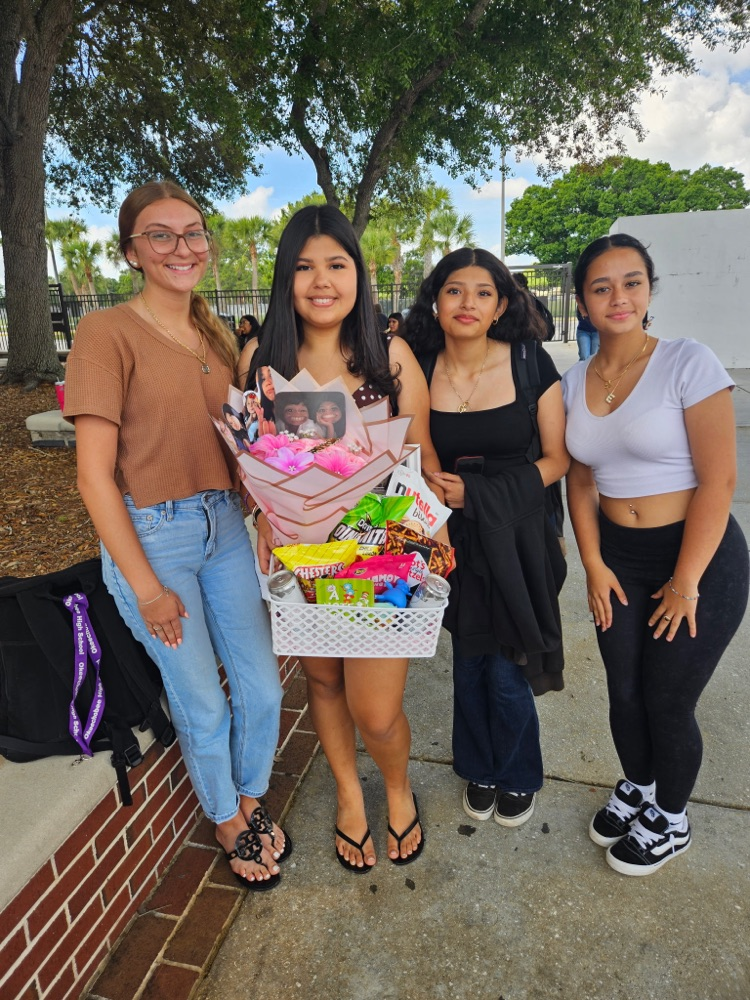 four students in school courtyard