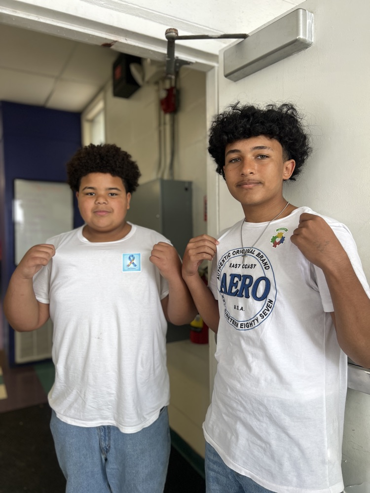 two students wearing autism awareness sticker