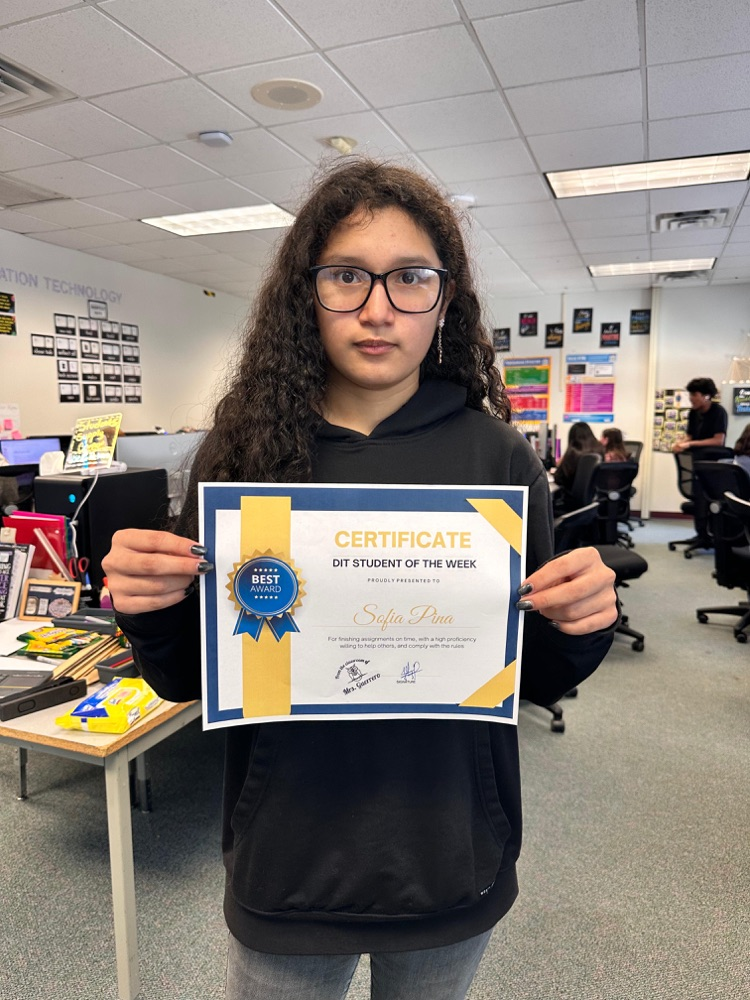 student holding DIT certificate
