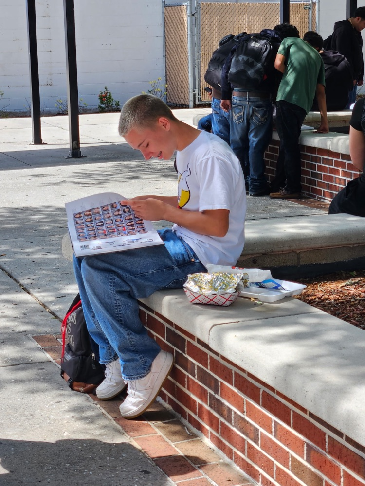 student looking at year book 