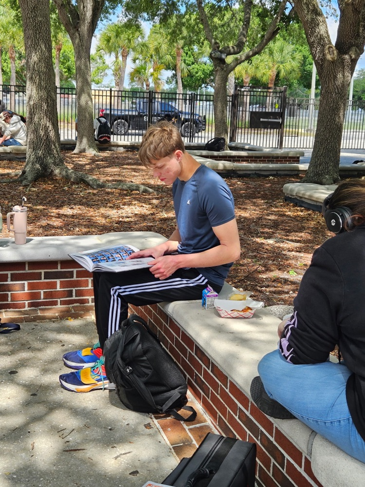 student looking at yearbook 