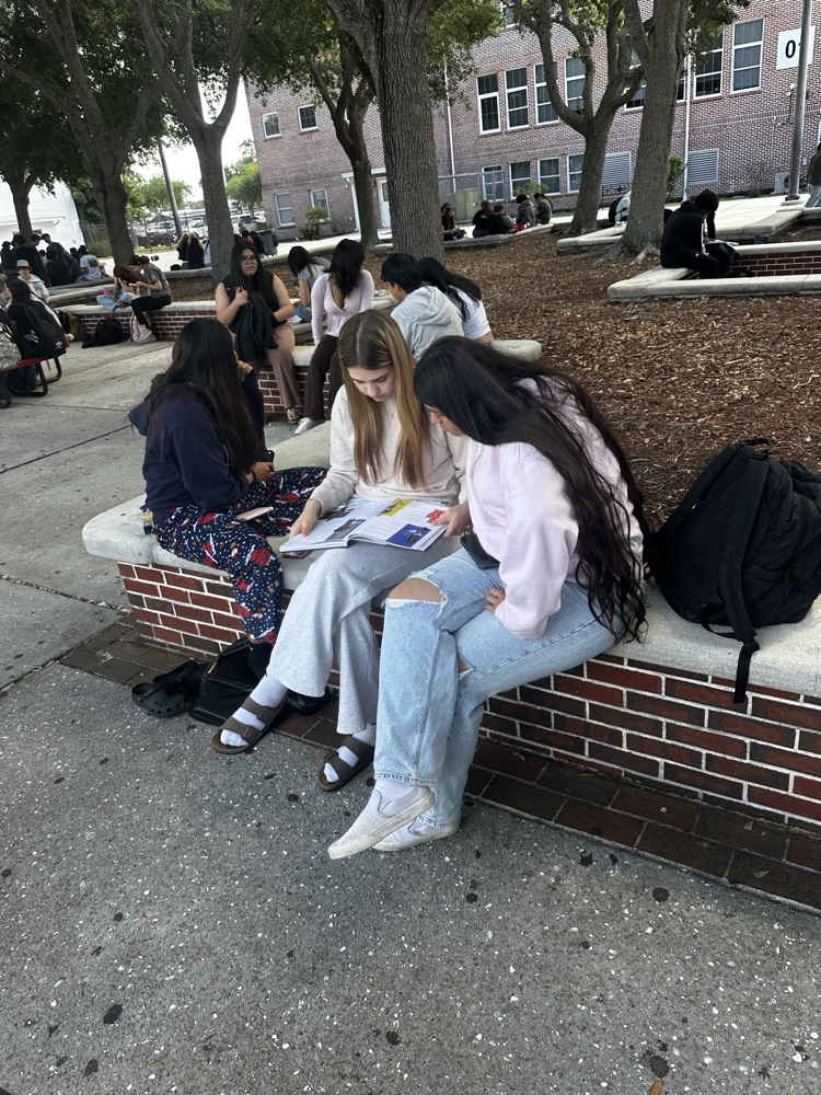 students looking at yearbook S