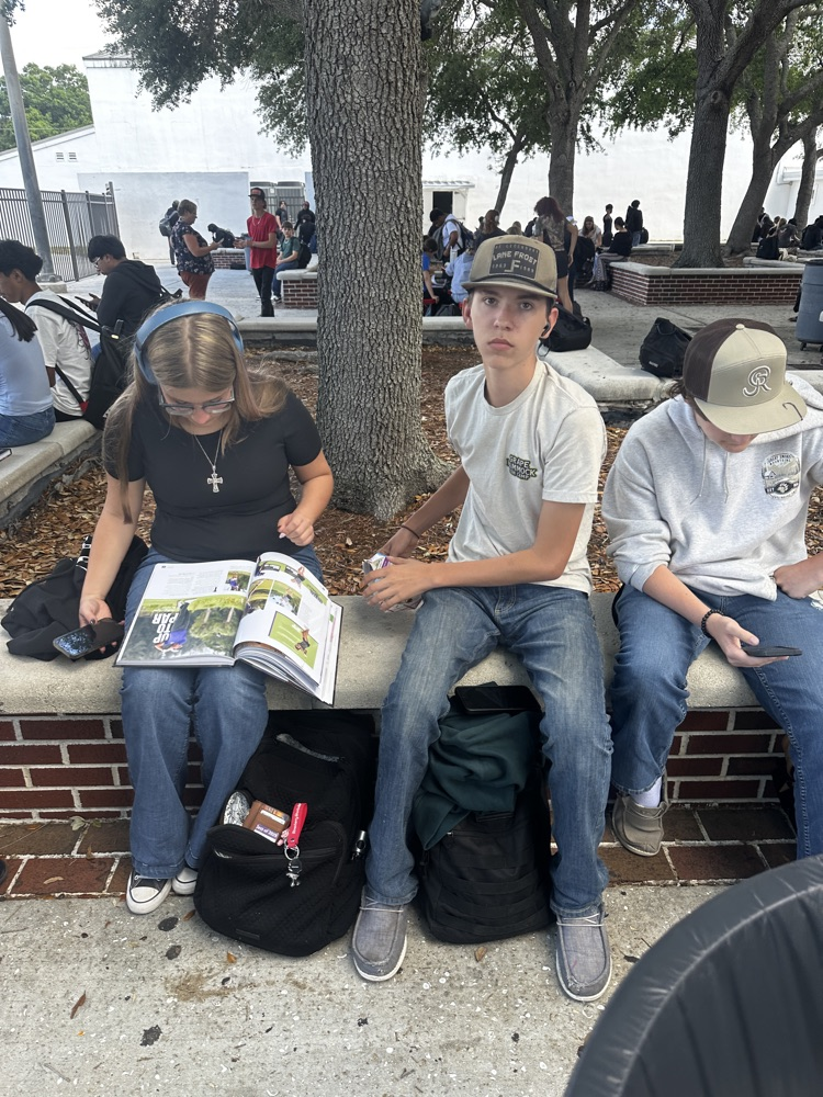 students looking at yearbook S