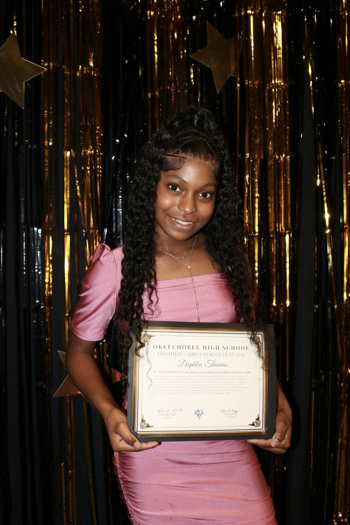 student holding certificate