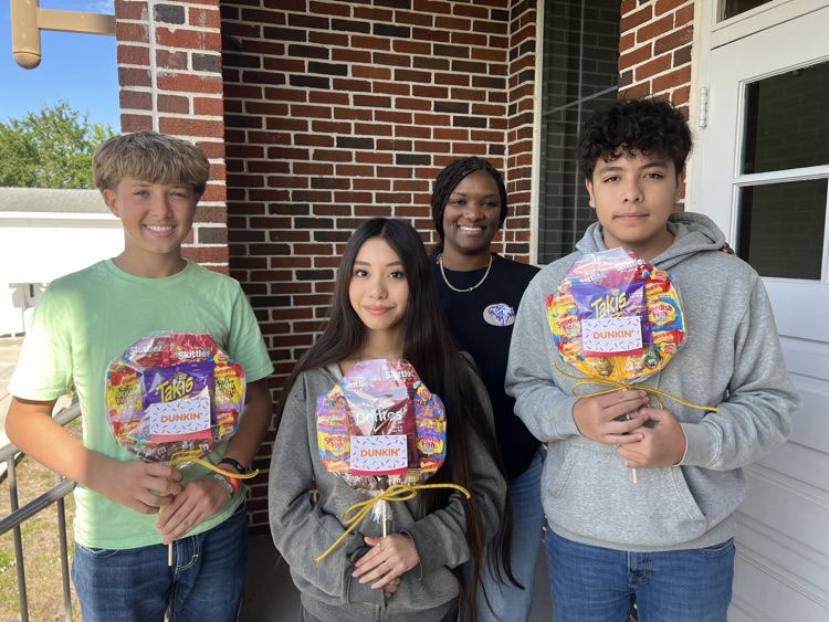 three students and guidance counselor with raffle gifts 