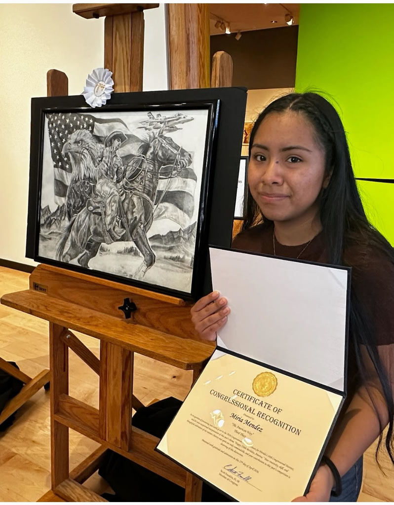 student showing art work