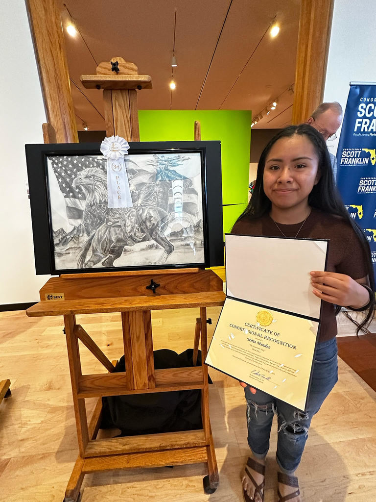 student showing art work