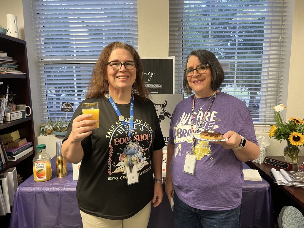 two teachers holding breakfast treats in principals office