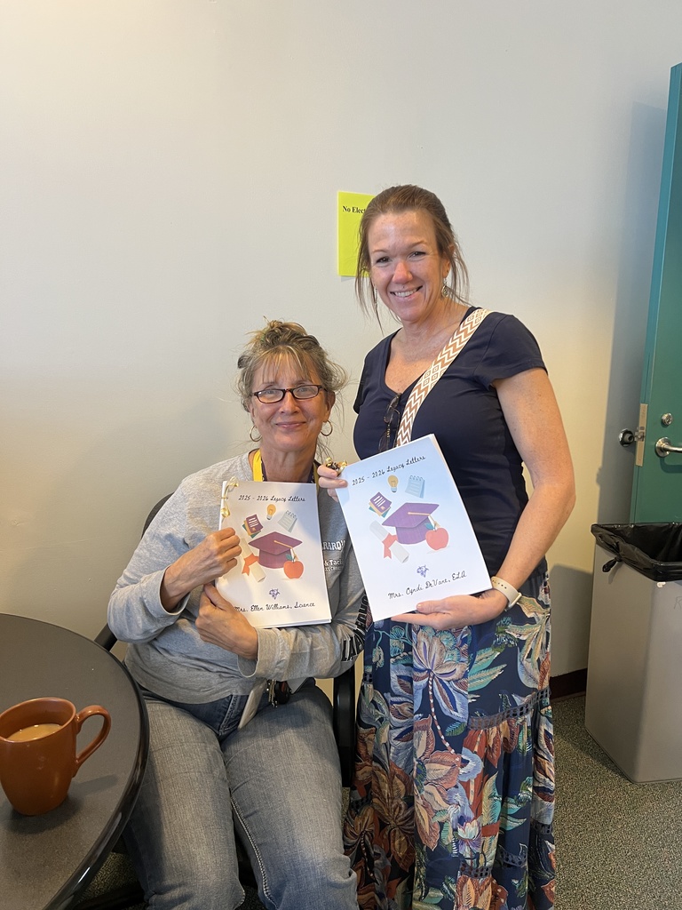 two teachers holding letters from students