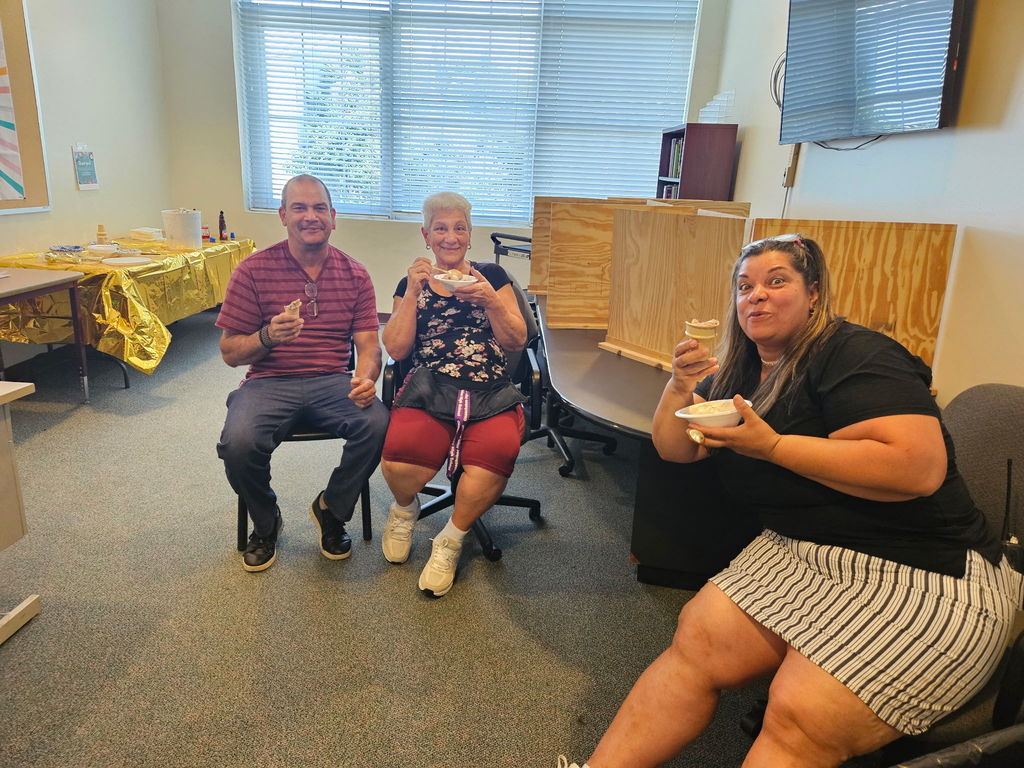 three custodians eating icecream