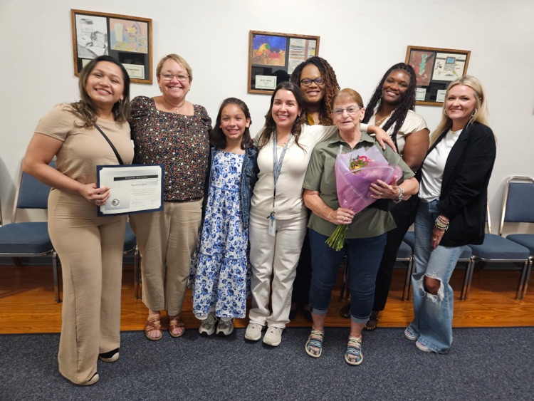teachers hugging at school board meeting
