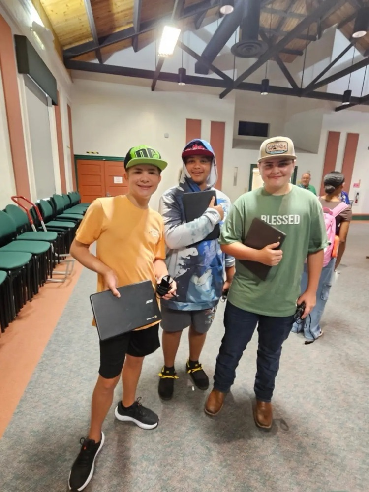 three students with chromebooks