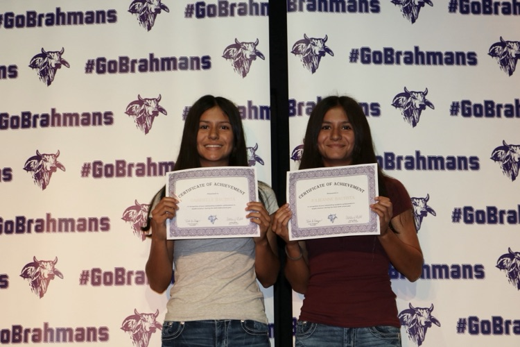 students with certificates on stage