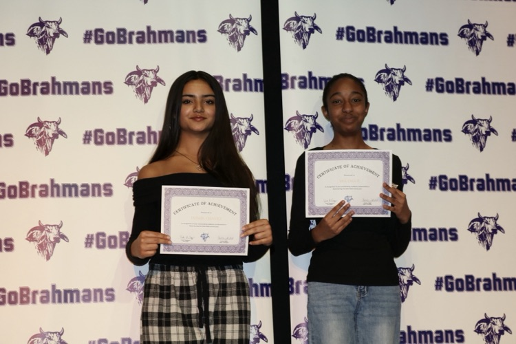 students with certificates on stage
