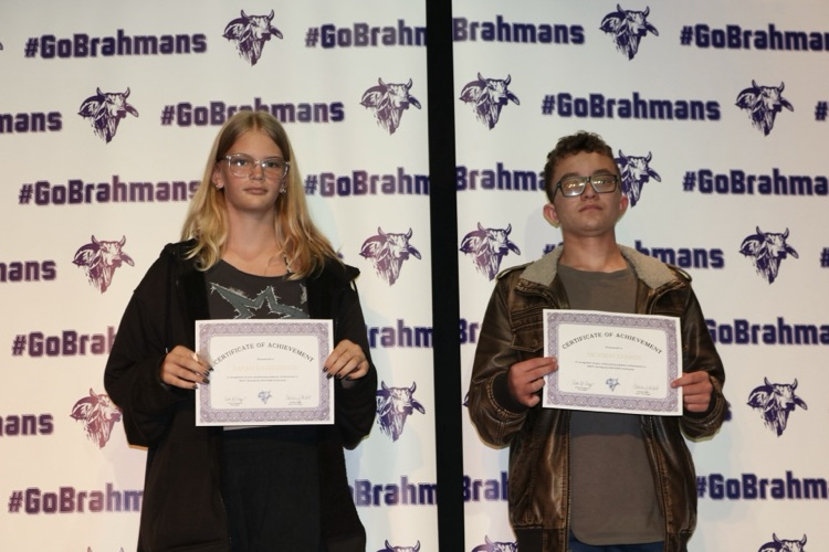 students with certificates on stage