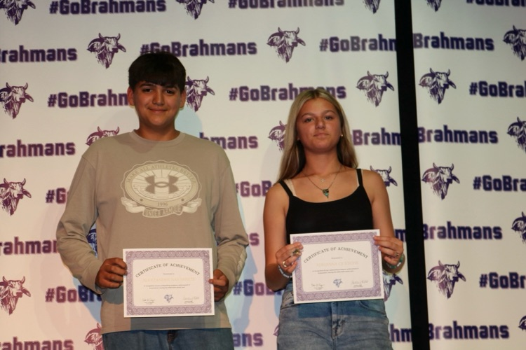 students with certificates on stage
