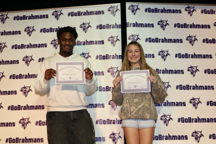 students with certificates on stage