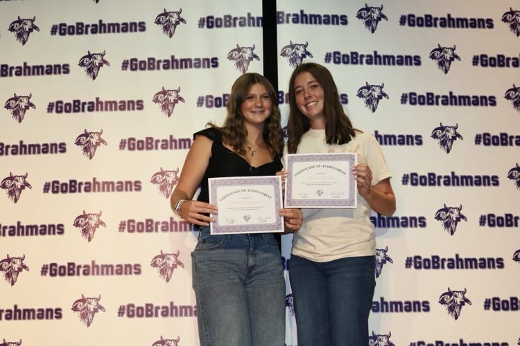 students with certificates on stage