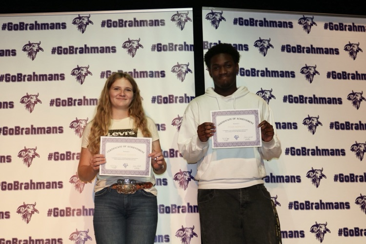 students with certificates on stage