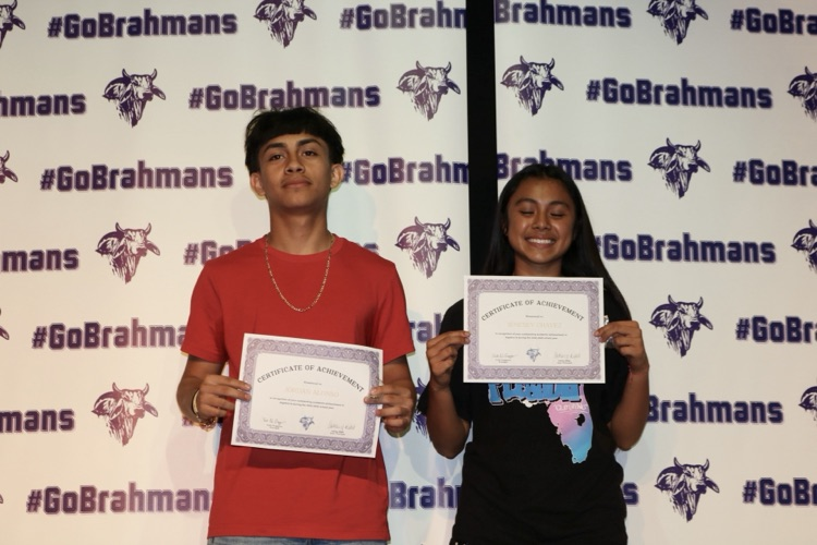 students with certificates on stage