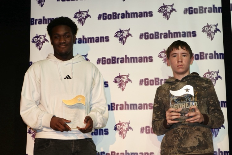 students on stage with award