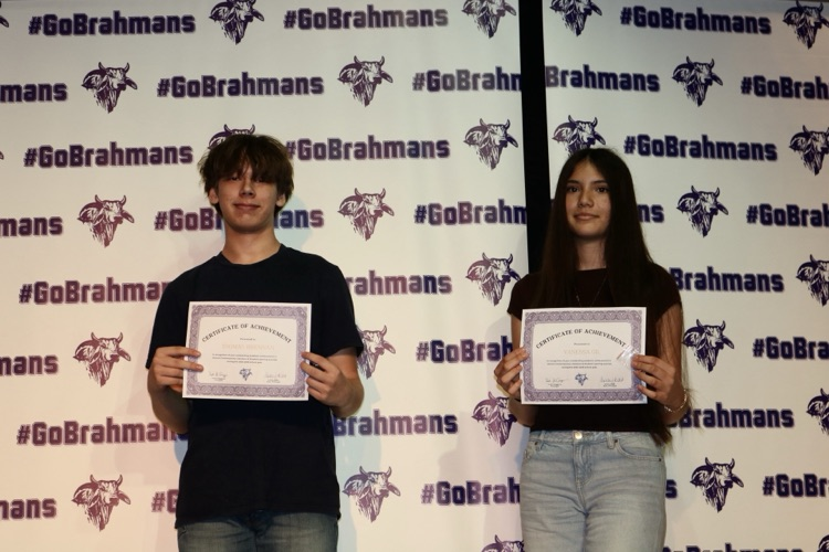students on stage with awards