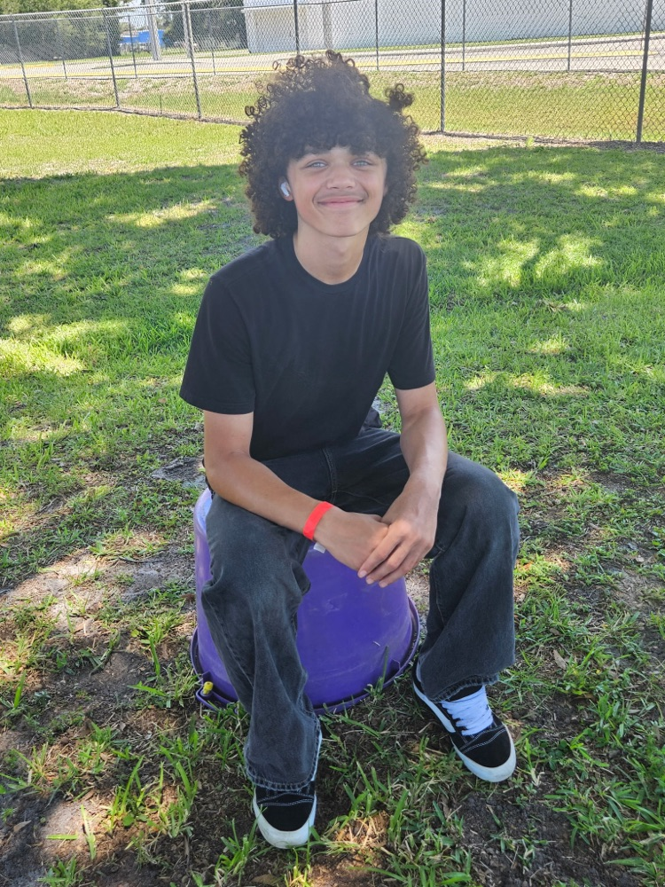 student sitting in school field