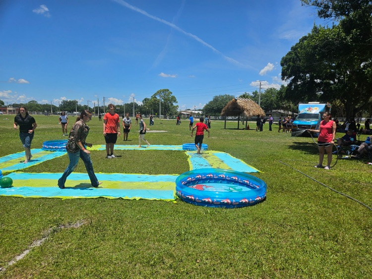 students playing on water slide